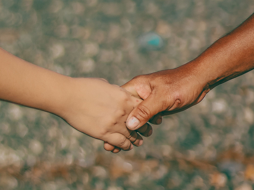 Two people holding hands