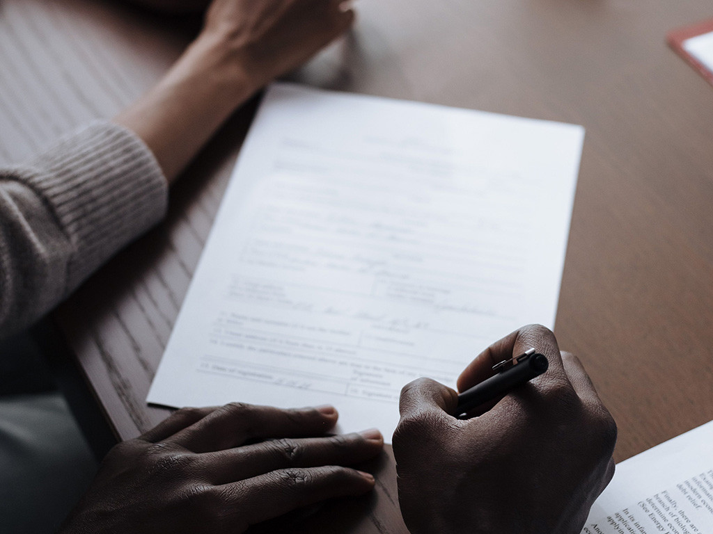 Couple signing a written agreement at a table