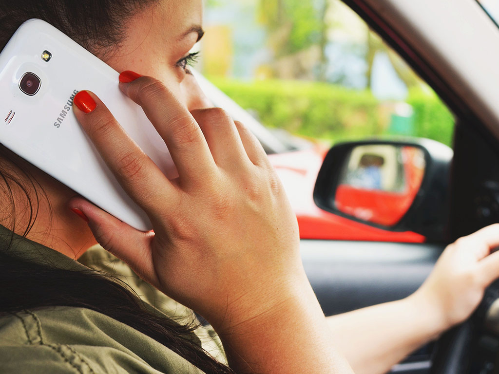 Driver using a mobile phone at the wheel