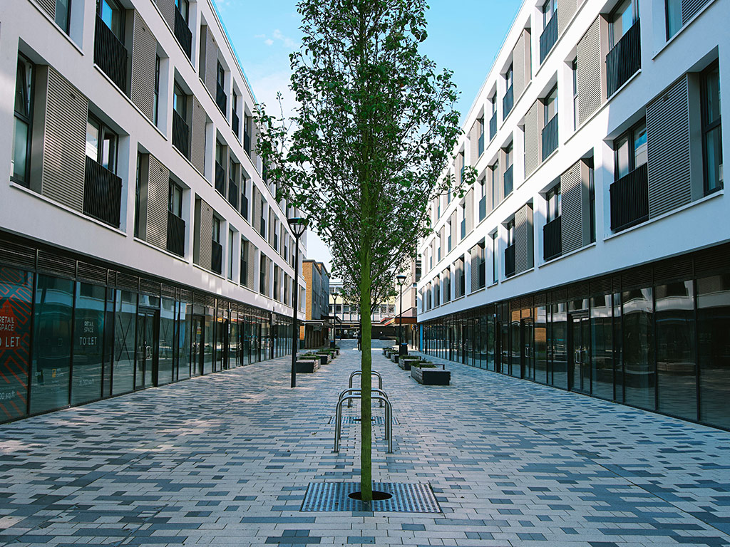 Modern buildings along a paved pedestrian street