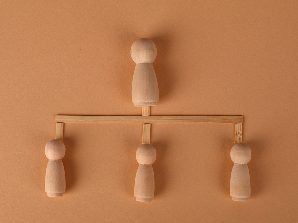 Wooden figures arranged as a family tree