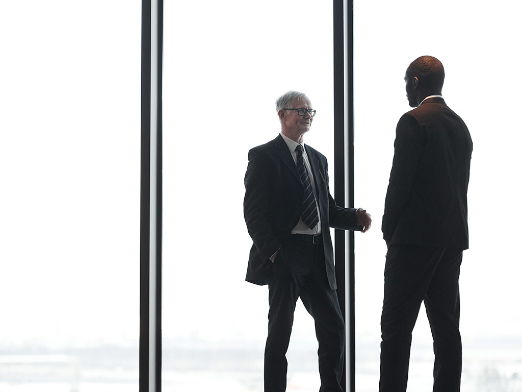 Two businessmen talking in an office