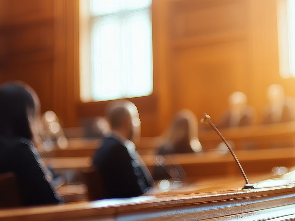 Courtroom with people seated before the bench