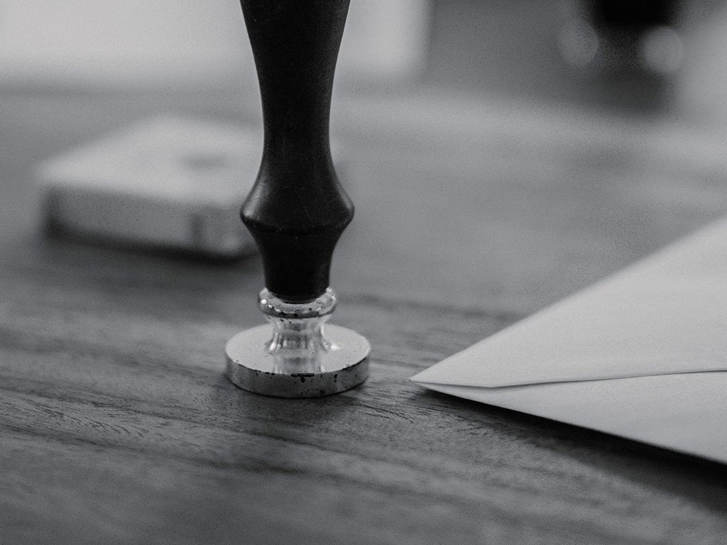 Wax seal stamp beside an envelope